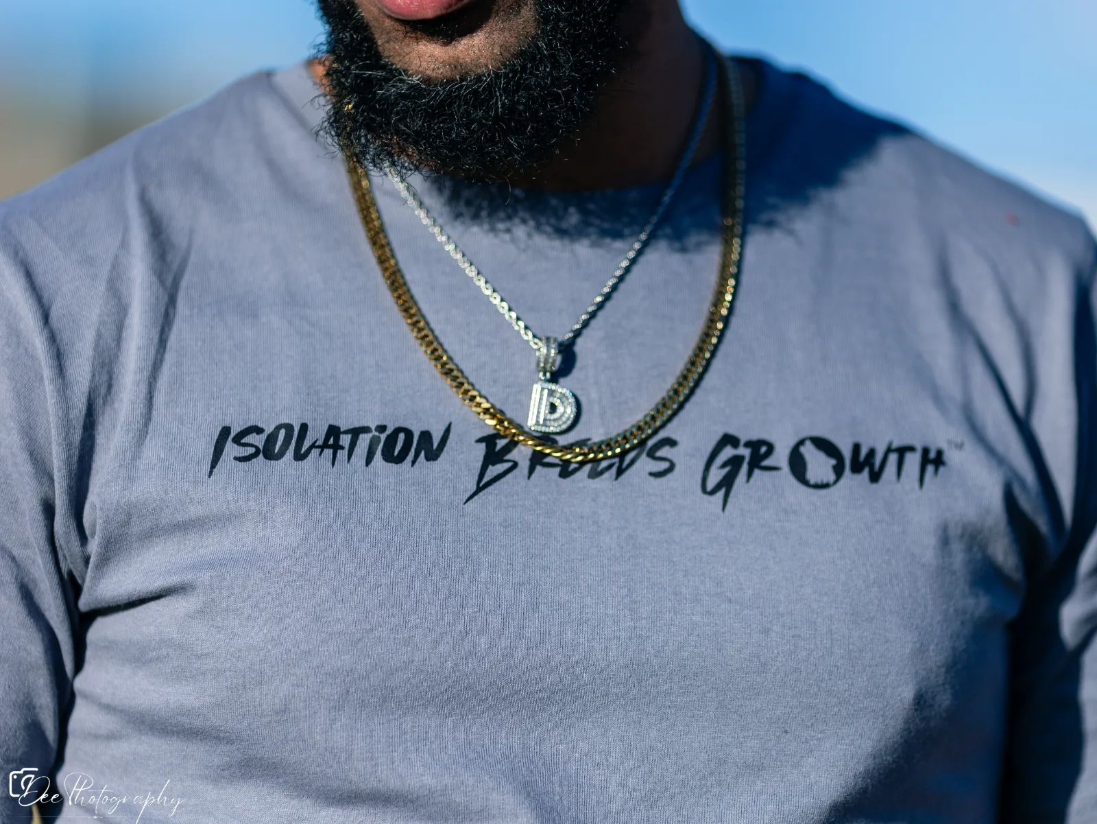Close-up of a model wearing an Isolation Breeds Growth T-shirt